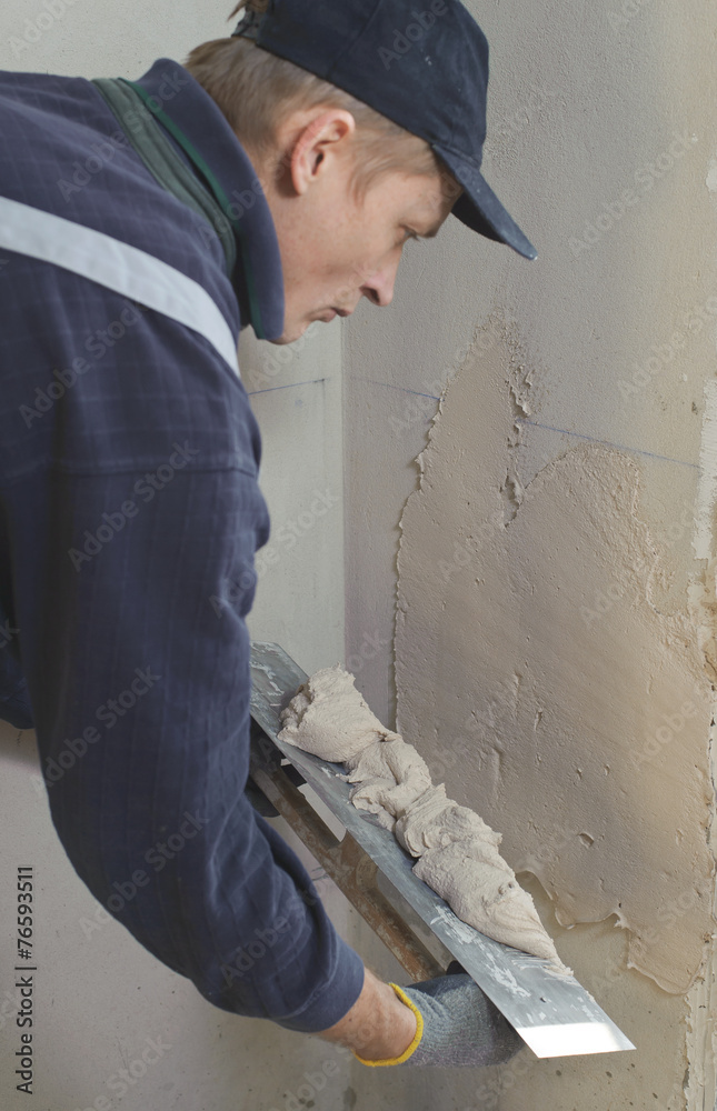Man gets manually gypsum plaster Man gets manually gypsum plaster