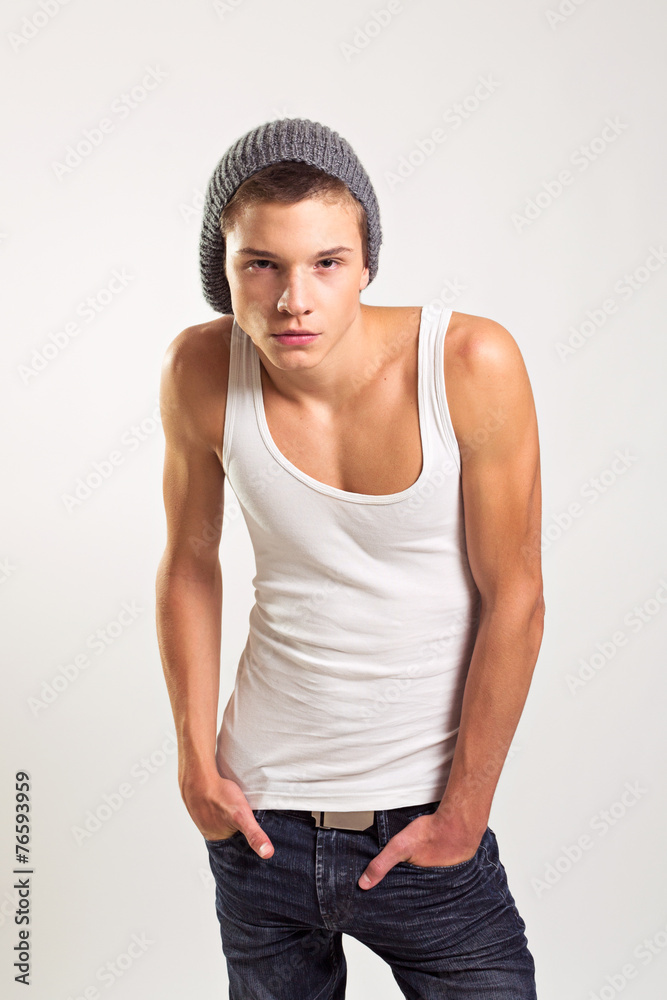 Hipster male fashion model in tank top jeans and beanie Stock Photo | Adobe  Stock