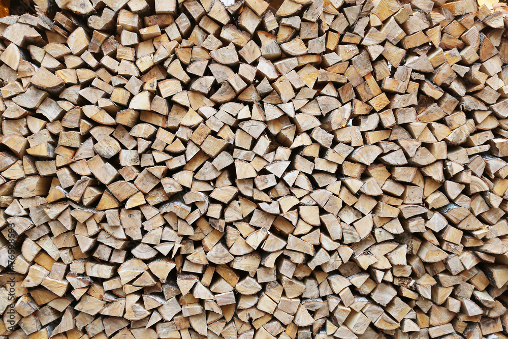 firewood stacked for storage, background