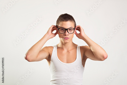Young male model with eyeglasses and white tank top