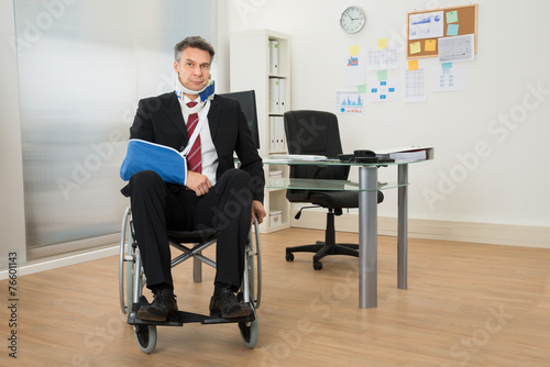 Handicapped Businessman Sitting On Wheelchair