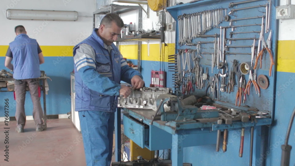 auto mechanic reassembles a motor with a wrench - dolly auto mechanic reassembles a motor with a wrench - dolly