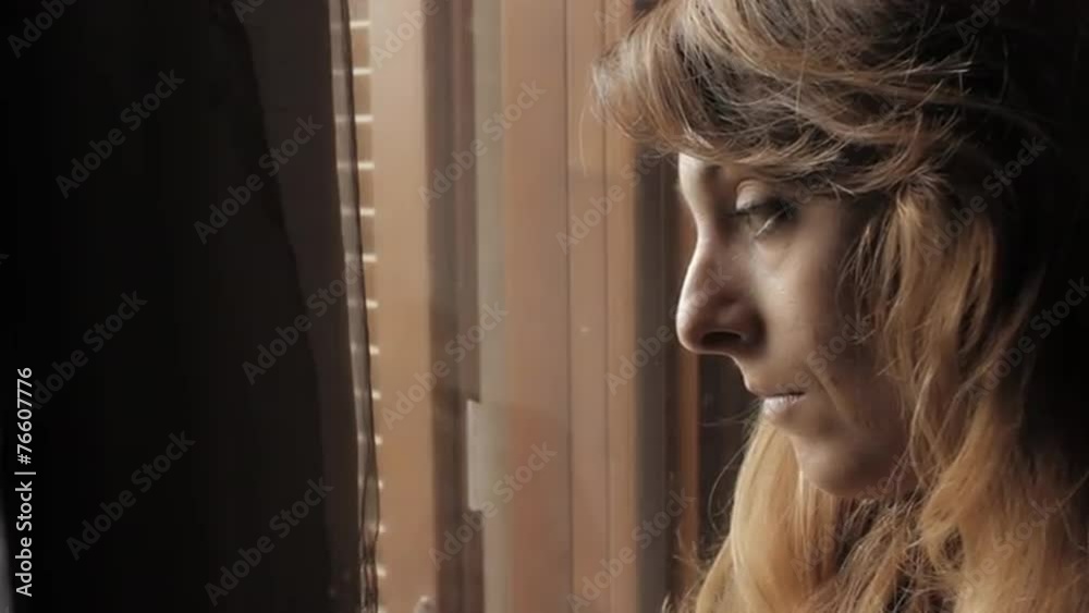 Sad girl near window thinking about something Sad girl near window thinking about something
