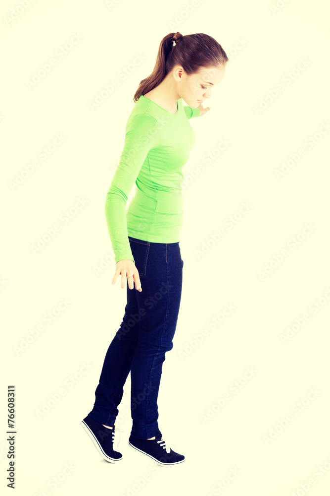 Attractive woman standing and looking down. Attractive woman standing and looking down.