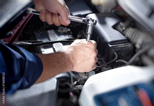 Mechanic working in auto repair garage © grinny