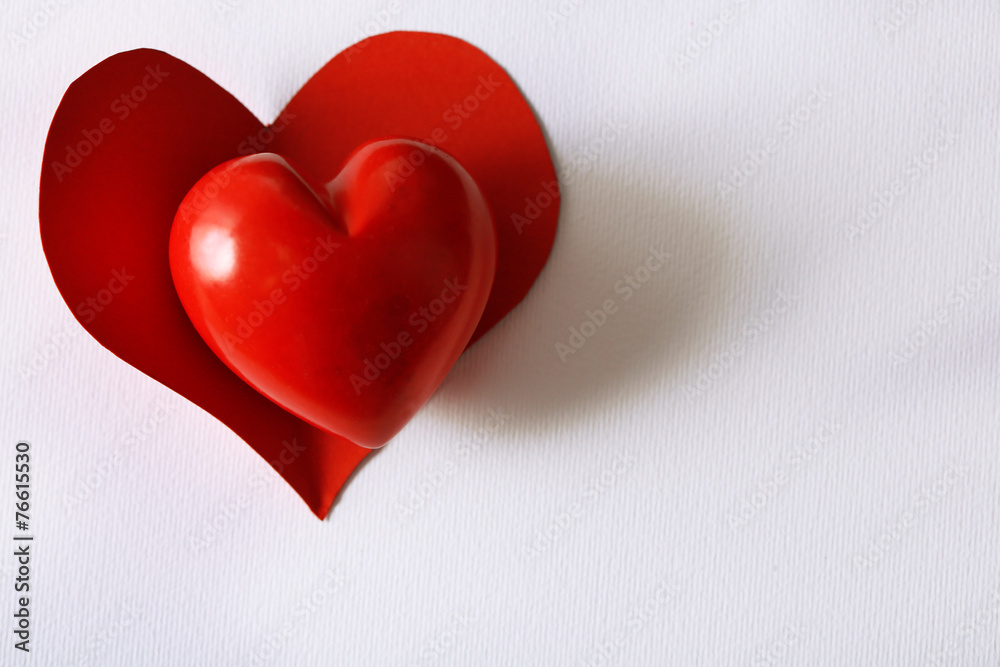 Beautiful decorative heart on white paper background, close-up Beautiful decorative heart on white paper background, close-up