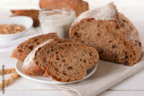 Tasty bread on table on light background