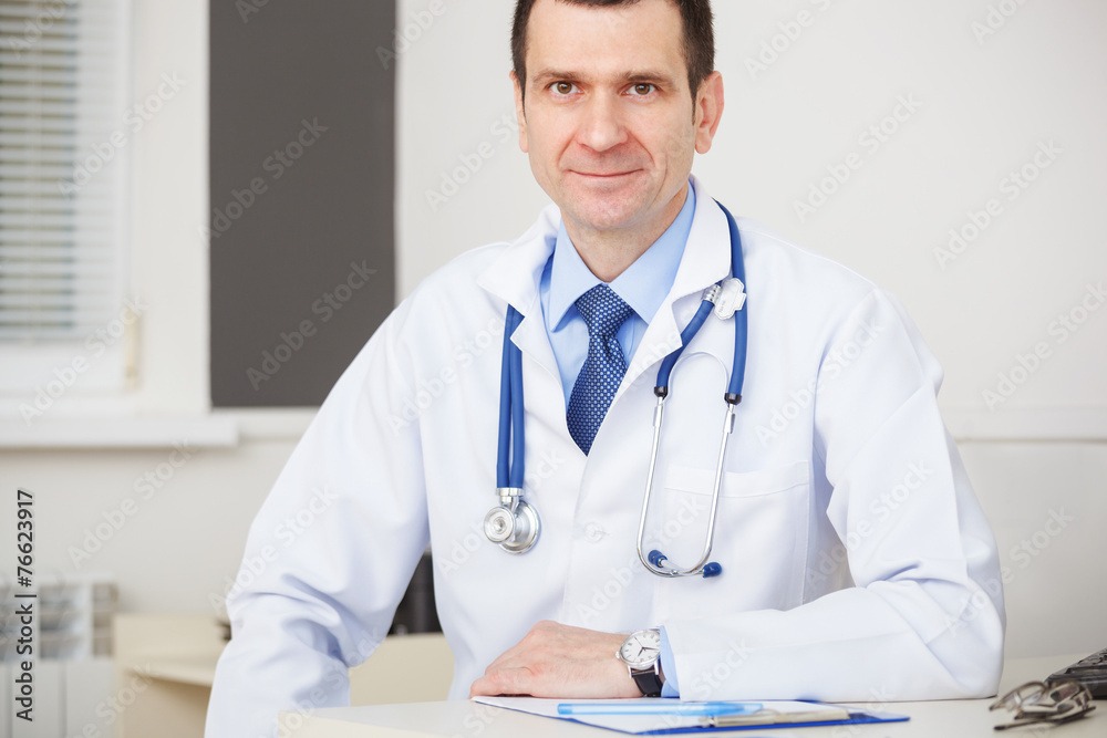 Confident doctor with stethoscope looking at the camera. Confident doctor with stethoscope looking at the camera.