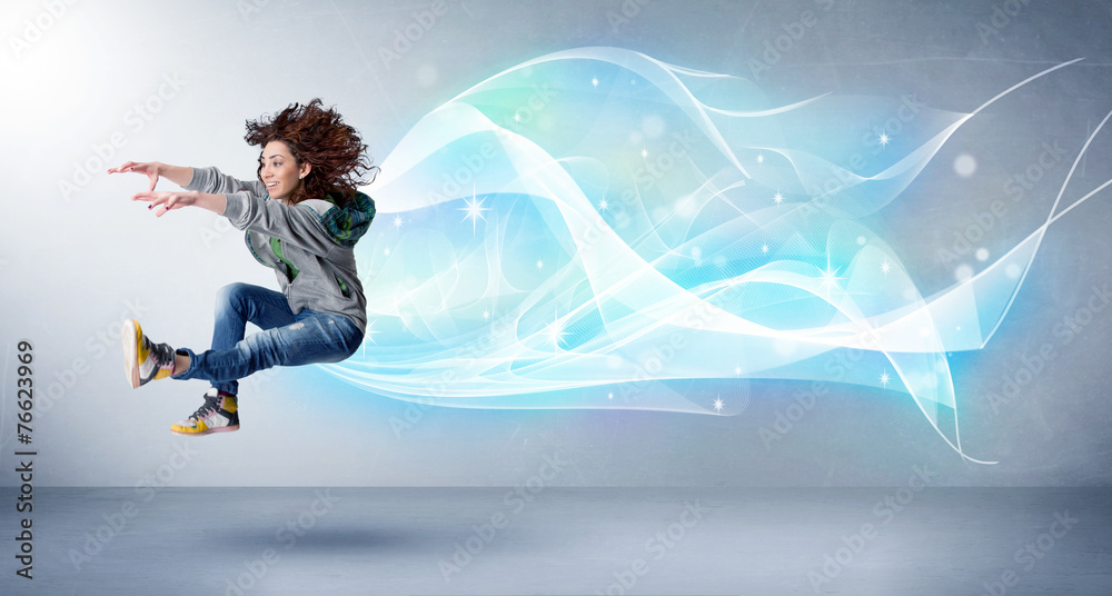 Cute teenager jumping with abstract blue scarf around her Cute teenager jumping with abstract blue scarf around her