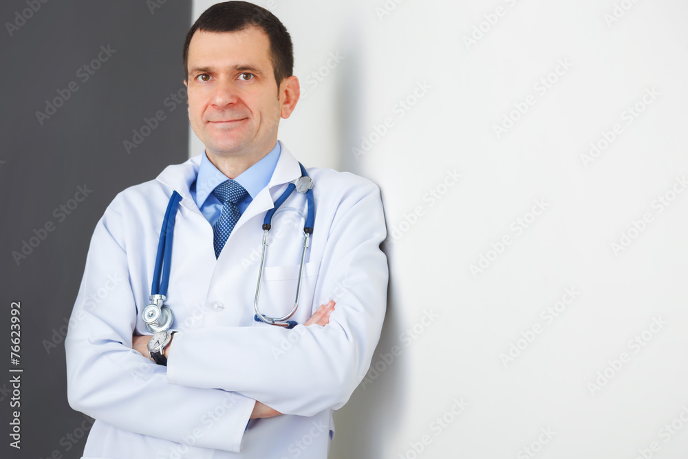 Portrait of confident doctor with crossed hands looking at the c Portrait of confident doctor with crossed hands looking at the c