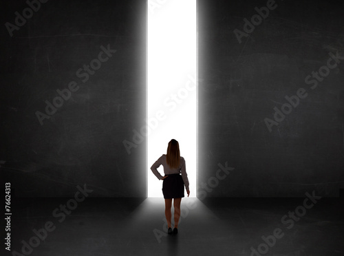 Business person looking at wall with light tunnel opening © ra2 studio