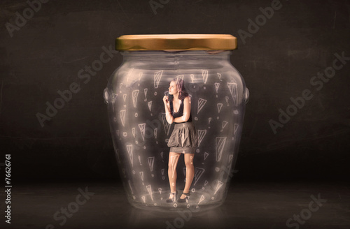 Business woman trapped in jar with exclamation marks concept photo