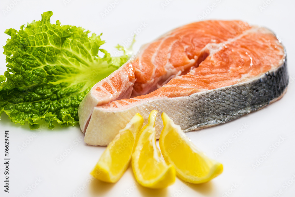 Raw Salmon Red Fish Steak with Herbs and Lemon isolated on White Raw Salmon Red Fish Steak with Herbs and Lemon isolated on White
