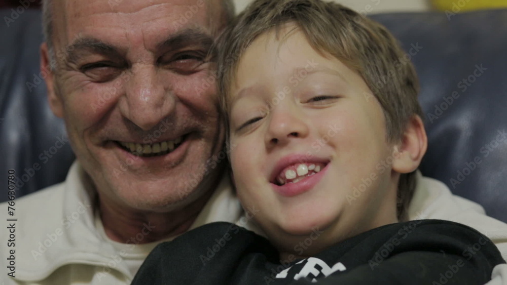 grandfather and grandson laughing and looking at the camera - old man and child grandfather and grandson laughing and looking at the camera - old man and child