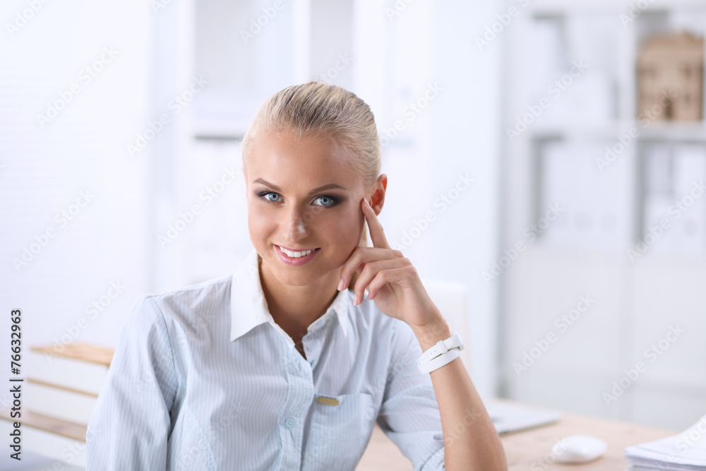 Attractive businesswoman sitting in the office Attractive businesswoman sitting in the office