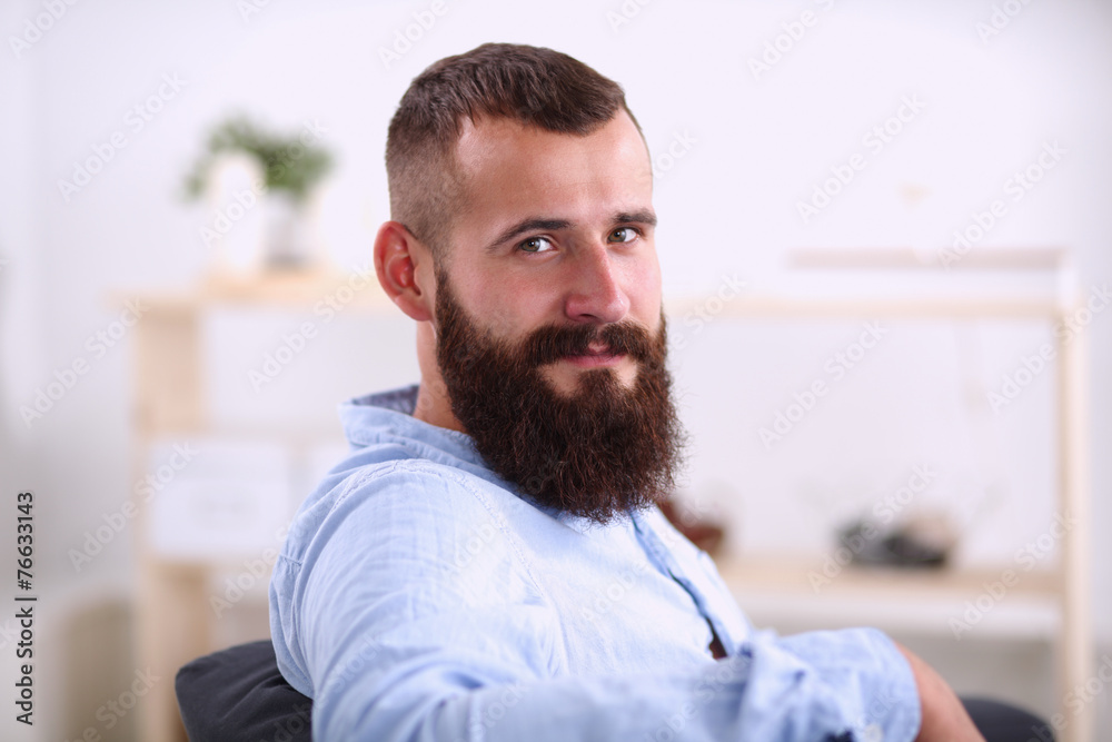 Young businessman sitting on chair in office