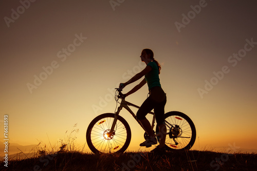Biker-girl at the sunset on mountains © Maygutyak