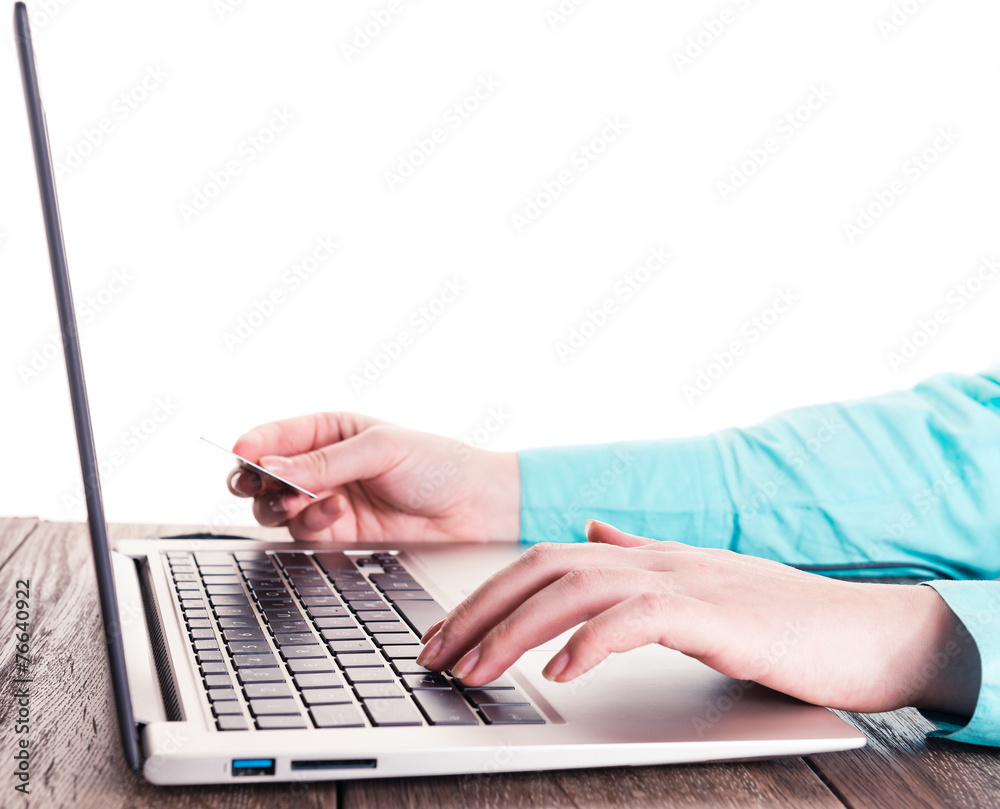 Female hands with credit card during shopping through Internet Female hands with credit card during shopping through Internet
