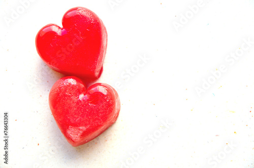 Two red ice cubes in shape of hearts