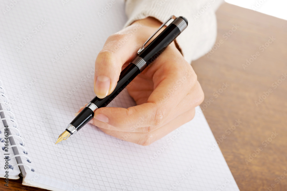 Hand writes with a pen in a notebook Hand writes with a pen in a notebook