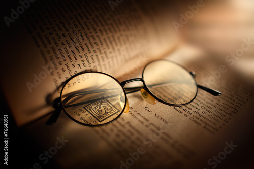 libro antico con occhiali photo
