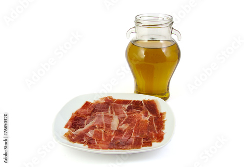 Spanish serrano ham with olive oil on white background