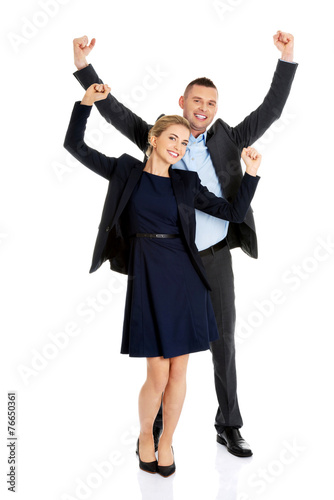 Victorious business couple with hands up