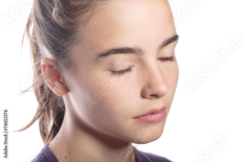 portrait of a teenage girl with closed eyes, isolated on white