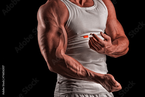 a muscular man with a syringe