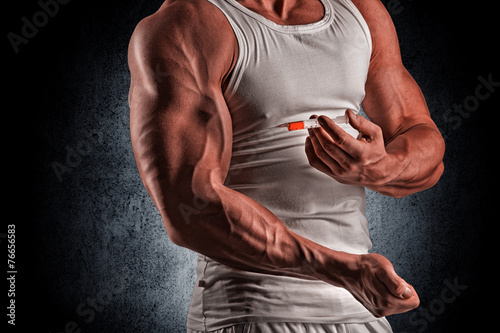 a muscular man with a syringe