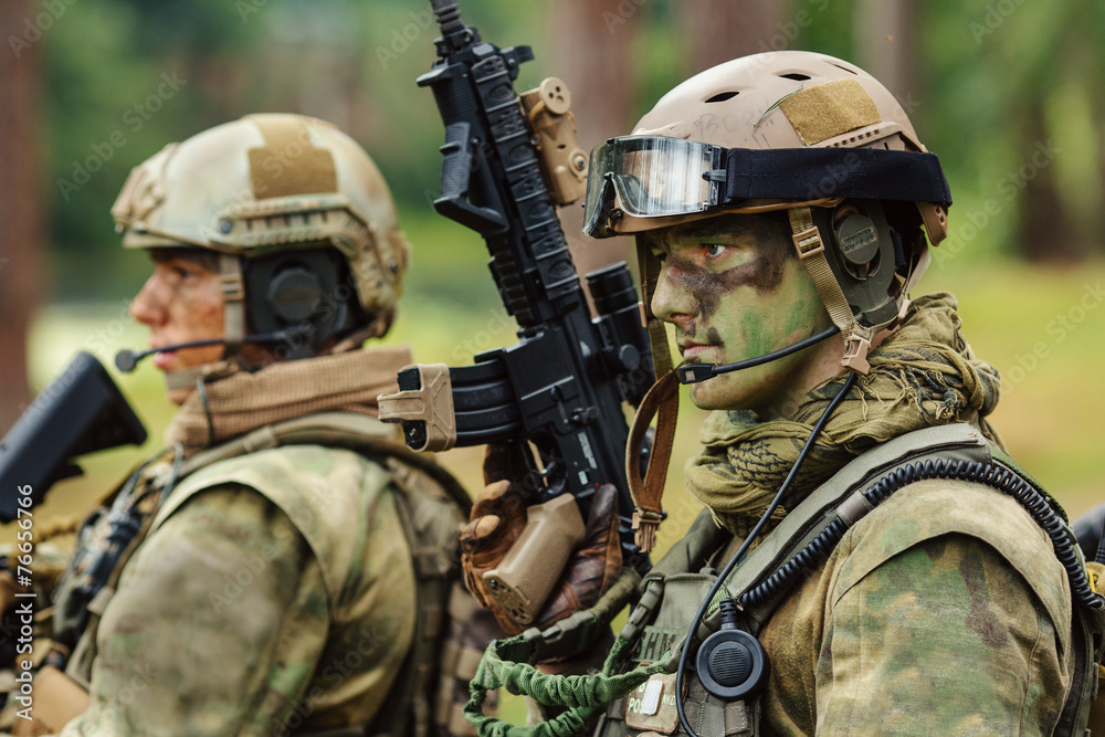 Fototapeta premium soldier stands with arms and looks forward