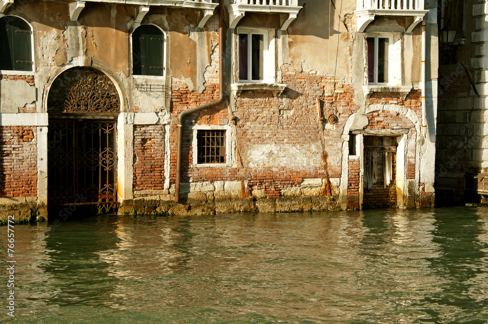 Old brick buildings on a Venice's narrow canal