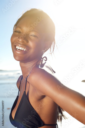 Wallpaper Mural Happy african american woman at the beach in bikini Torontodigital.ca