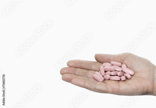 pink pills on a palm