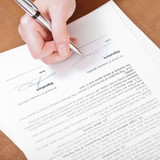 client signs an agreement by silver pen
