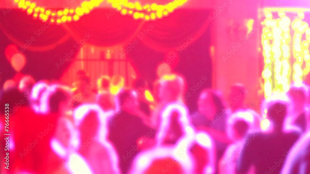People dancing in spot light rays lumiere on a disco