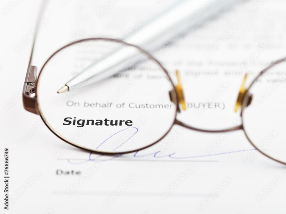 signature of agreement and pen through eyeglasses signature of agreement and pen through eyeglasses