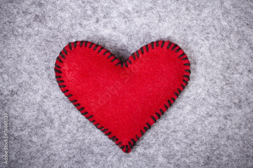 red felt heart on a gray background