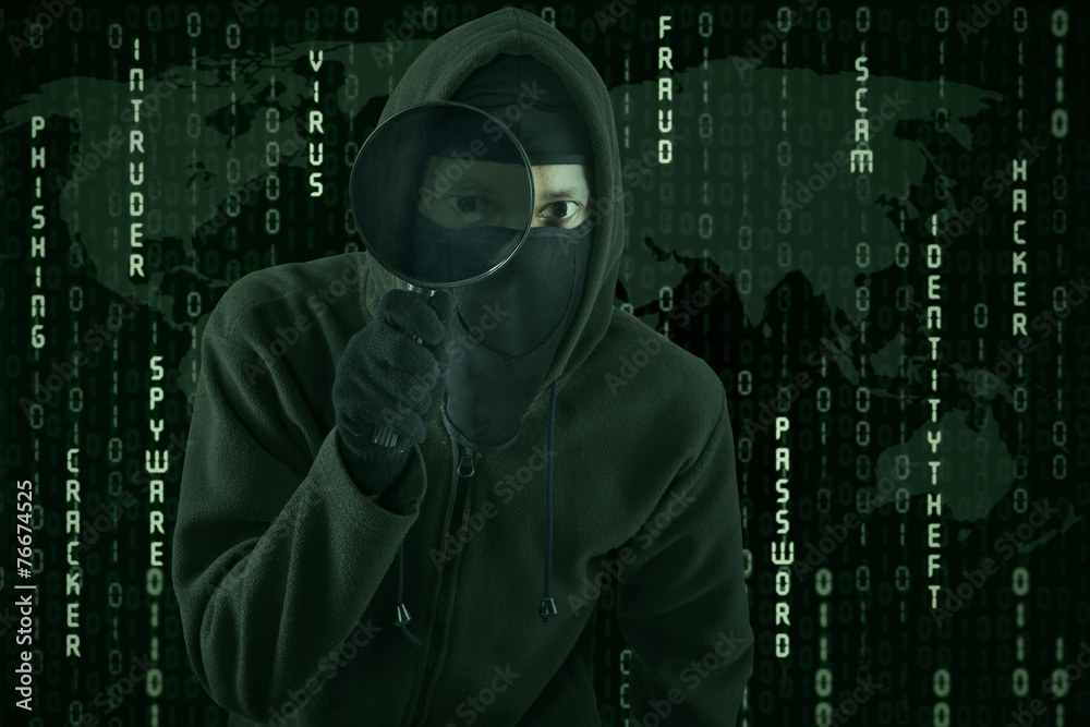 Hacker using magnifying glass for spying Hacker using magnifying glass for spying