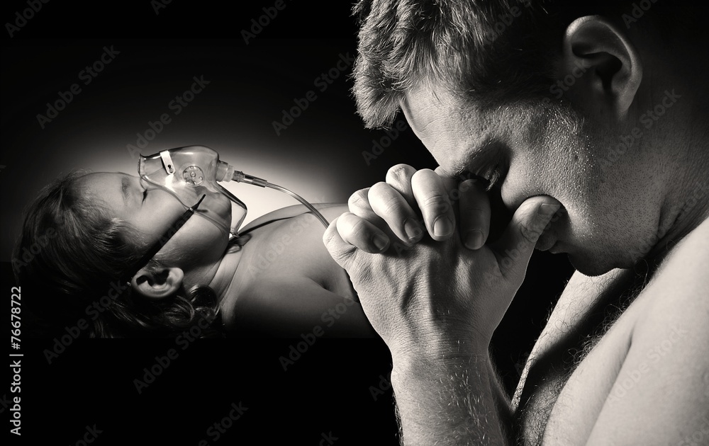 Father prays for the health of seriously ill daughter.