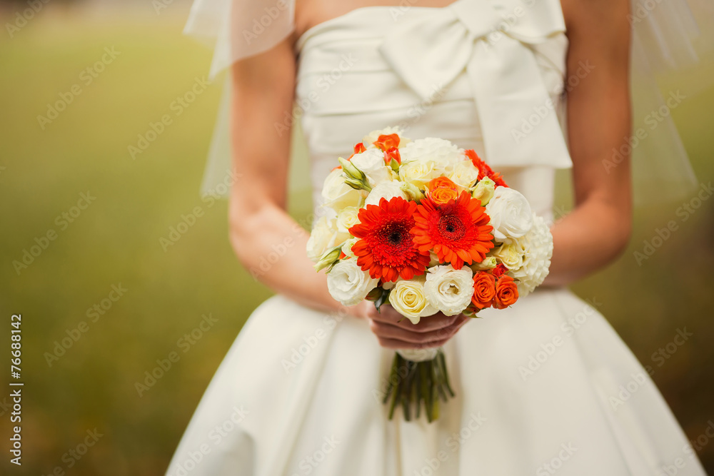 bride holding wedding bouquet of various flowers. bride holding wedding bouquet of various flowers.