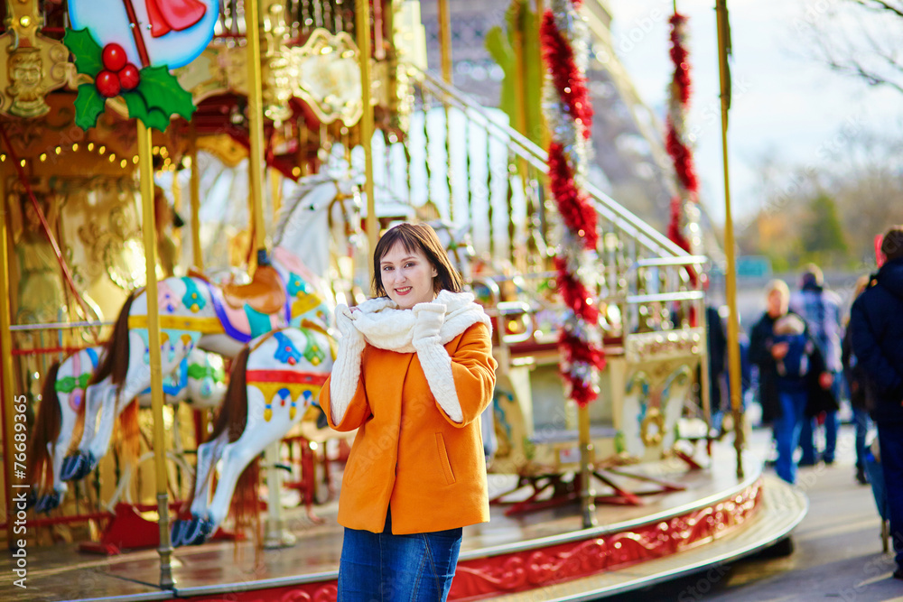 Beautiful young girl near merry-go-round