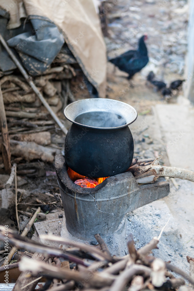 boiling pot for cooking on ground with background of hen and chi boiling pot for cooking on ground with background of hen and chi