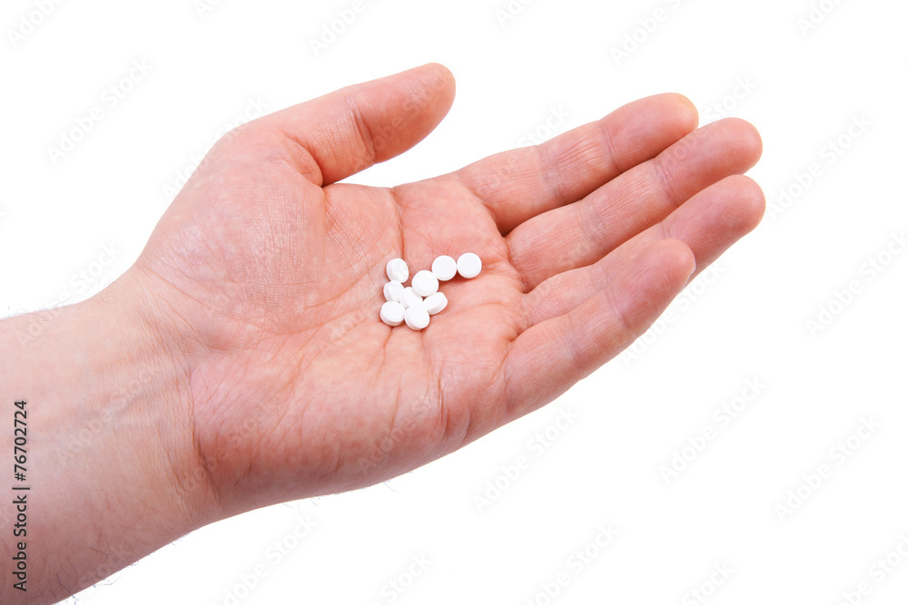 Hand holding pills. Isolated on white background Hand holding pills. Isolated on white background