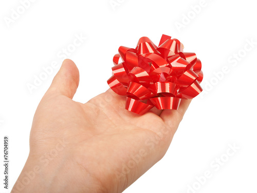 Fototapeta Naklejka Na Ścianę i Meble -  Hand holding against red christmas bow for gift.
