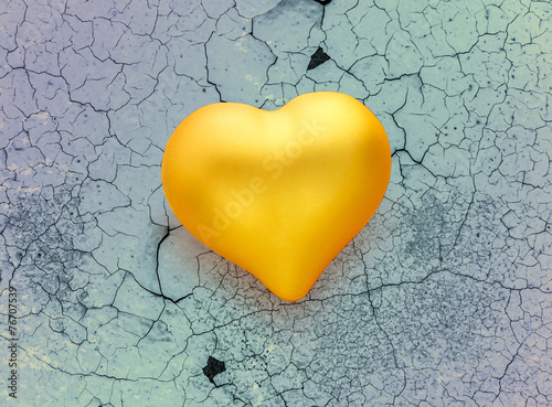 Golden heart on cracked background