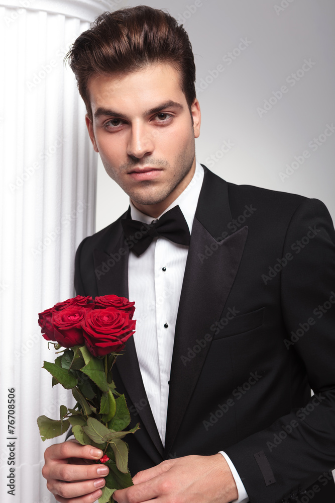 Handsome business man leaning on a white colum Handsome business man leaning on a white colum