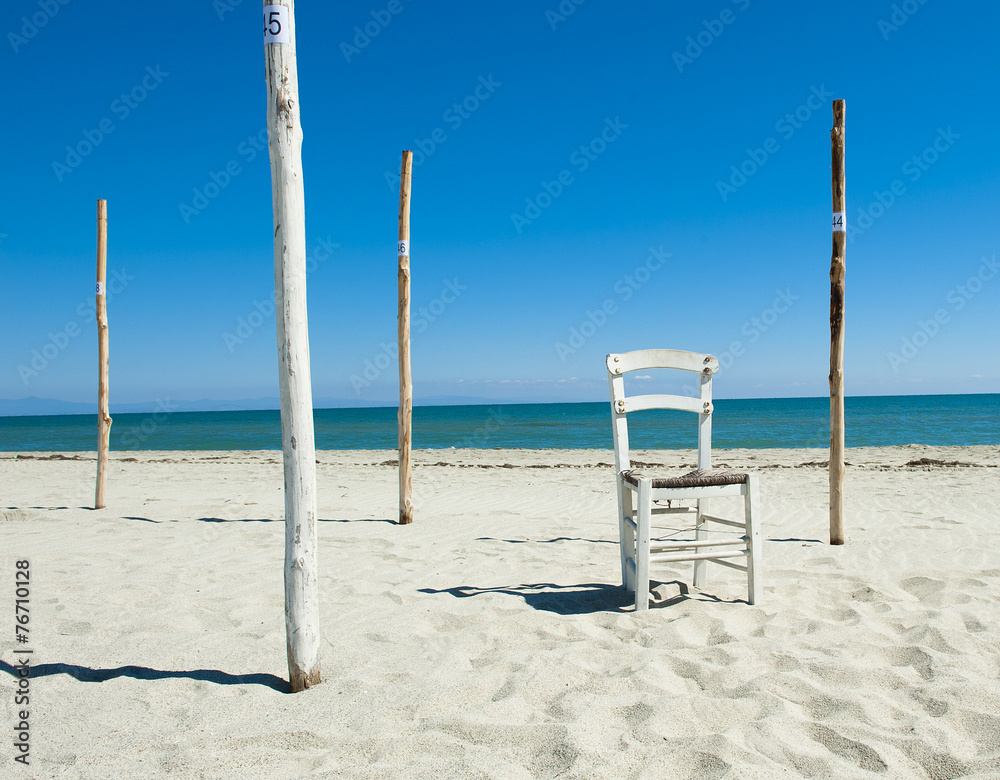 forgotten white chair and umbrella columns on autumn beach forgotten white chair and umbrella columns on autumn beach