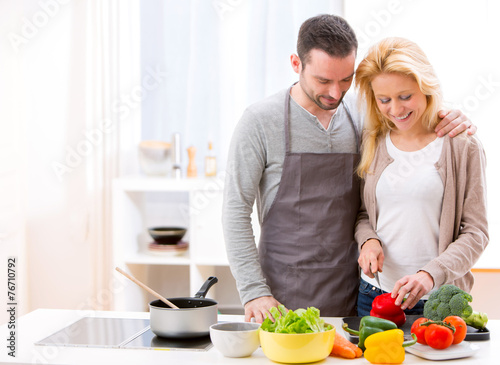 Young attractive couple cooking in a kitchen