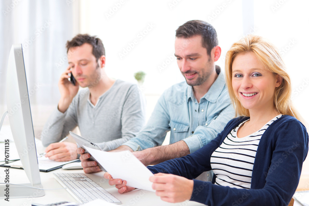 Young attractive people working together at the office Young attractive people working together at the office